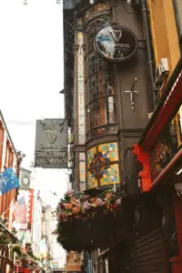 Exterior of a Guinness pub in Dublin, featuring colorful stained glass and floral decor