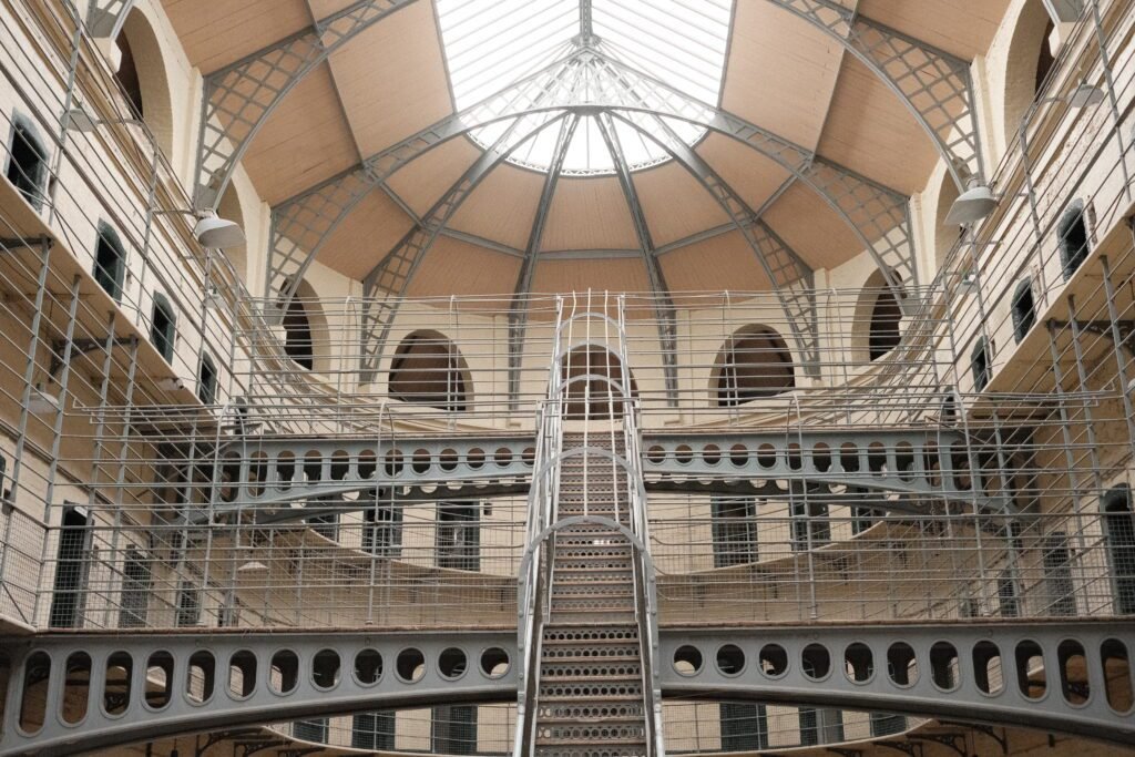 The central hall inside Kilmainham Gaol, a historic prison in Dublin, Ireland. This is a must-see when it comes to Irish landmarks to see and experience during your visit to Dublin.