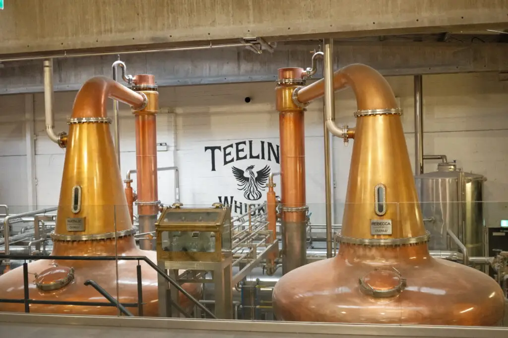 Copper stills inside Teeling Whiskey Distillery in Dublin, Ireland, showcasing the whiskey-making process.