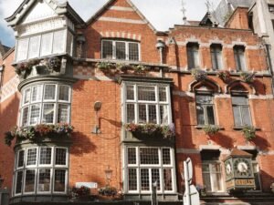 Historic pub in Dublin City Centre, a must-visit spot when visiting Dublin for the first time, showcasing traditional Irish architecture with flower-adorned windows.