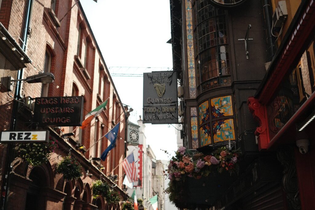 Exterior view of The Stag’s Head, one of Dublin’s most historic pubs, featuring ornate tile work and signs promoting Guinness, food, and live music.