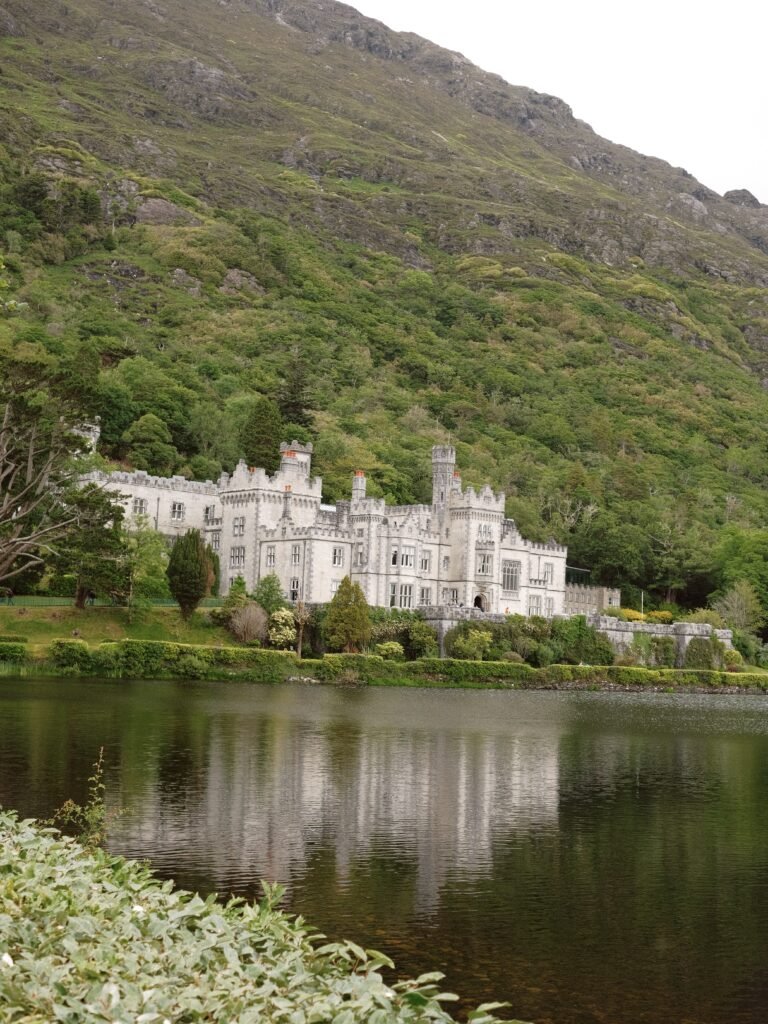 Kylemore Abbey nestled against the scenic hills of Connemara, a popular day trip destination from Galway, Ireland.