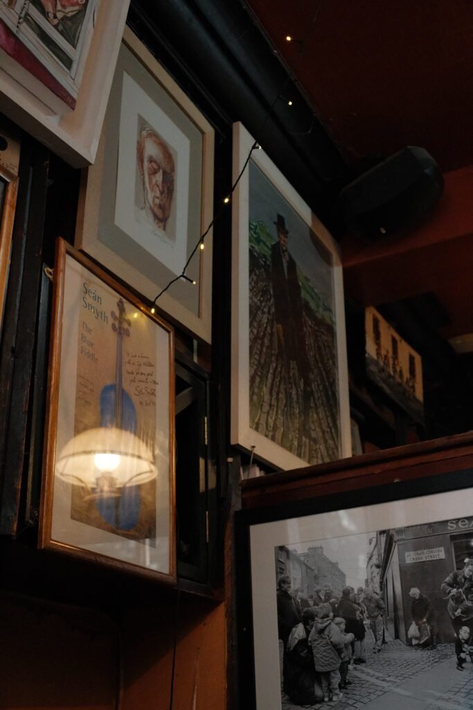 Interior of a Galway pub featuring framed artwork and historical photos on the walls, showcasing the rich cultural atmosphere of some of the best and most famous pubs in Galway, Ireland.