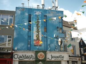 Colorful storefronts in Galway City featuring Claddagh Jewellers, a popular stop for visitors exploring historic sites and local shops as part of a 1-day itinerary.