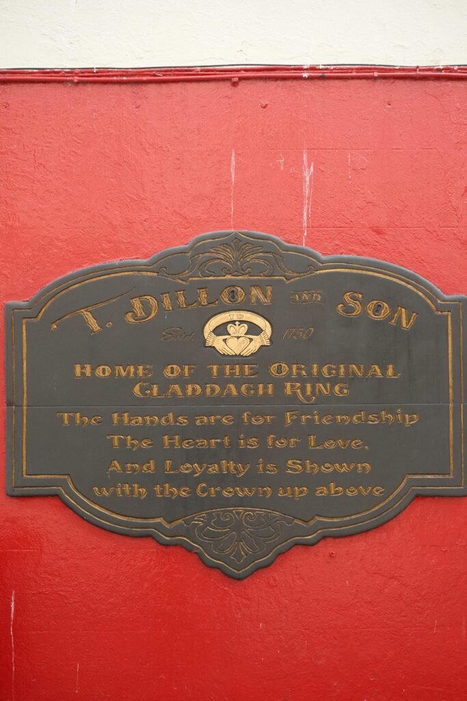 Sign for T. Dillon & Son, the original makers of the Claddagh ring, located in Galway City, Ireland, with the Claddagh symbol and its meaning inscribed.