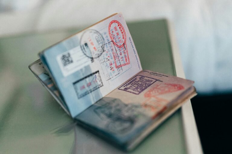 A close-up of a passport with multiple stamps from international destinations, symbolizing global travel.