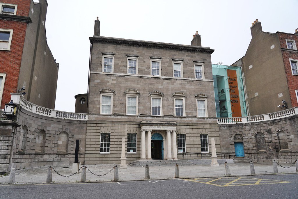 The grand exterior of the Hugh Lane Gallery in Dublin, showcasing neoclassical architecture with a modern glass extension.